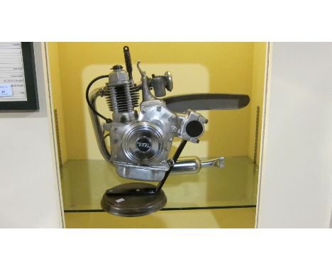 A Motomic clip-on motorcycle enginefitted with a carburettor and exhaust system, engine number 12D*70512*, mounted on base, c