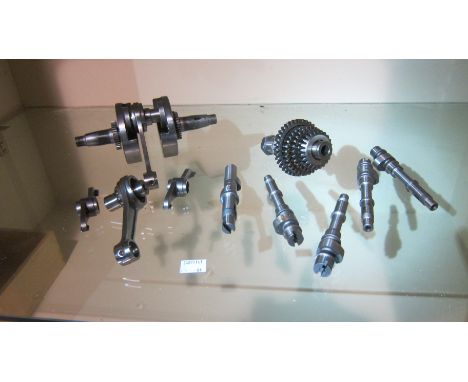 An unidentified selection of engine componentsincluding a crankshaft, five camshafts, part gear cluster, conrod and sundry pa