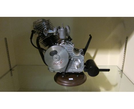 A Ducati Cucciolo clip-on engineengine number 301165, mounted on base, fitted with a carburettor and exhaust, condition and c