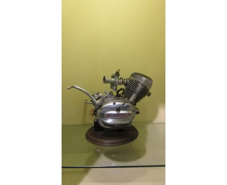 A Moto Morini P/4 engine and gearbox unitfitted with a carburettor, mounted on base, condition and completeness unknown, clos