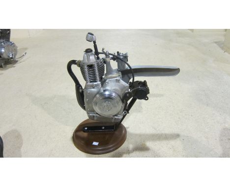 A Motomic clip-on motorcycle enginefitted with a carburettor and exhaust system, engine number 12-2 1486, mounted on base, co