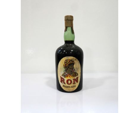 RON PUERTO-RICO C.1920'S
An ultra rare bottle of Rum from J. Amigo, Barcelona.  Approx. 1 Litre.  No Strength Statement.  We 