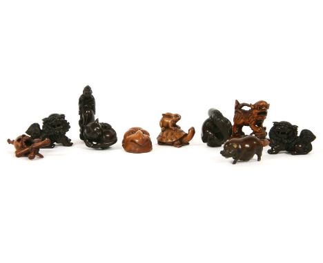 A collection of carved wood netsuke