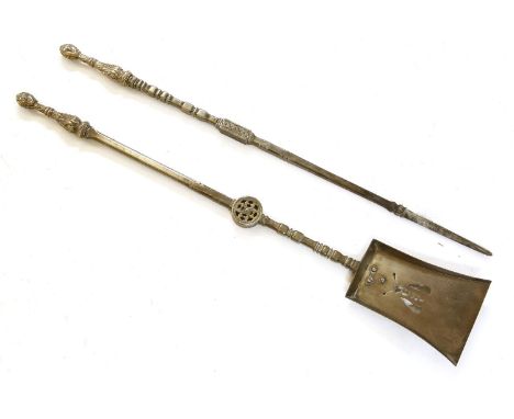 Two iron and nickel alloy fire tools, each with cast mask finial, the shovel with a pierced 'Bee', one 89cm long, the other 9