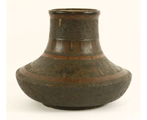 A Japanese vase, c.1900, of circular form, the depressed ceramic body decorated with scrolling leaves and gourds with cloison