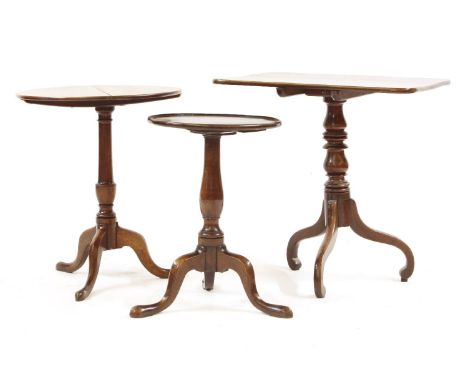 Three tripod tables, two oak, with circular tops, the other mahogany, 71cm widest