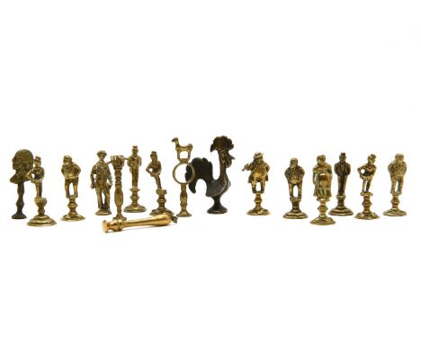 Eleven Victorian brass figural pipe tampers, and five others
