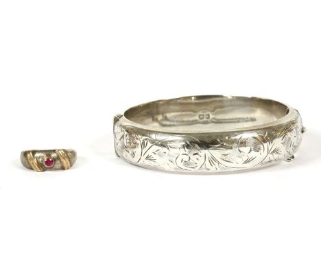 A silver single stone synthetic ruby ring, highlighted with reed gold coloured lines, a silver hinge bangle with engraved top