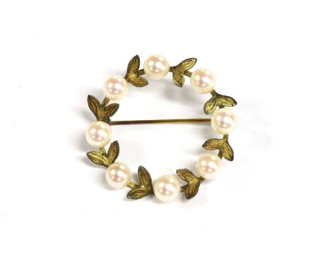 A gold cultured pearl wreath brooch, eight cultured pearl peg set to a ring of leaves, stamped 14k, 5.06g