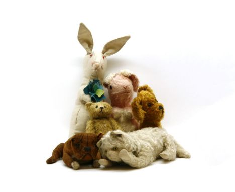 A collection of vintage stuffed toys, to include a bulldog, a cat, a bear, a dog and two rabbits