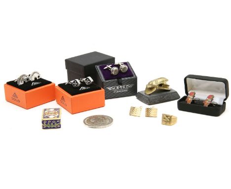 An assortment of items to include cufflinks, a scarab paperweight, and a reproduction Russian coronation medallion