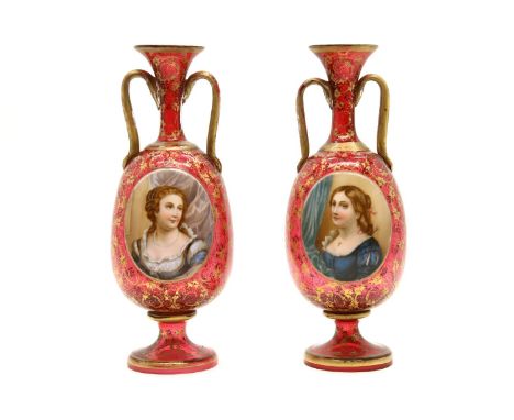 A pair of bohemian red and gilt decorated glass portrait vases, gilt worn, 30cm high