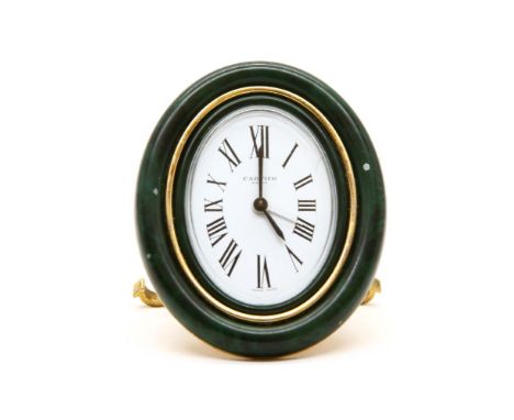 A Cartier easel alarm clock, the white dial with black Roman numerals, within a malachite style border, stamped 'Cartier, Par