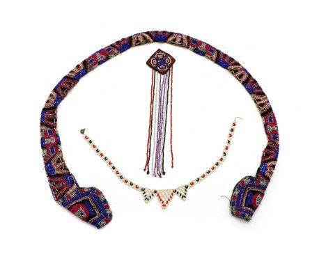 A coloured glass beadwork sash or net ornament, probably Native American, decorated with a geometric pattern, 94cm long, toge