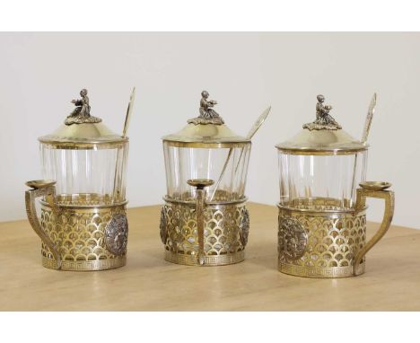 A set of three Russian silver gilt tea glass holders,bearing numerous marks to include Sazikov, Moscow city mark, assay mark 