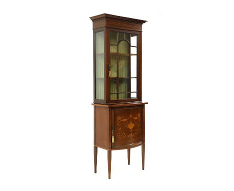 An Edwardian inlaid mahogany narrow display cabinet, the bar and glazed door above cupboard door on square tapering feet, 66c