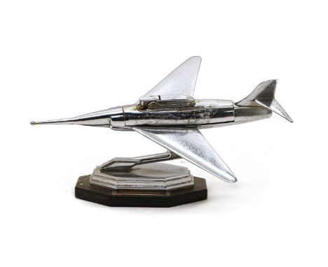 A chromed table lighter, in the form of a fighter jet, mounted on a stepped base, with a presentation plaque inscribed 'Prese