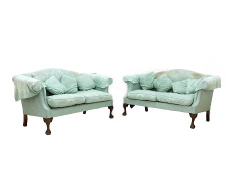 A pair of Chippendale style camelback sofas, upholstered in blue damask, with piped edges, raised on ball and claw feet, 165c