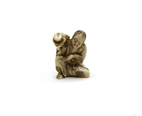 A Japanese ivory netsuke of a seated man and Frog, c.1910, 3cm wide x 4cm highCondition report: No apparent losses, with some