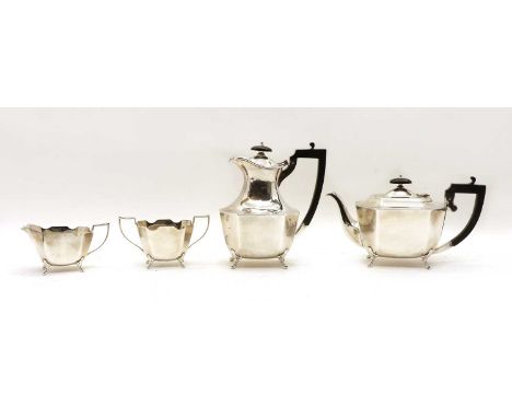 A silver four piece tea service of angular form, Sheffield 1929, on paw feet comprising; a teapot, water jug, milk jug and su