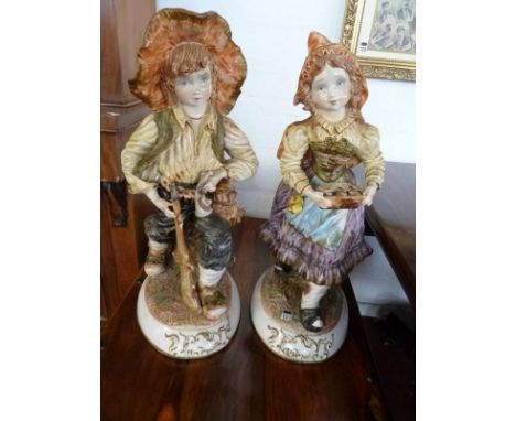 Pair of Capo Di Monte decorated figures modelled as young farm workers (slight damage to both figures)