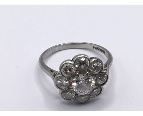 A Quality Vintage diamond and platinum ring the central stone approximately 0.5carat flanked by eight 0.1 carat stones approx