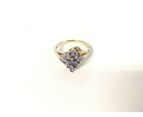9ct gold ring set with light blue stones. 3.44g and Size R.
