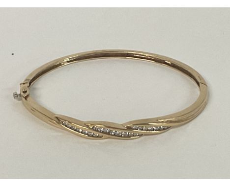 A multi Diamond set bangle in 9ct Gold