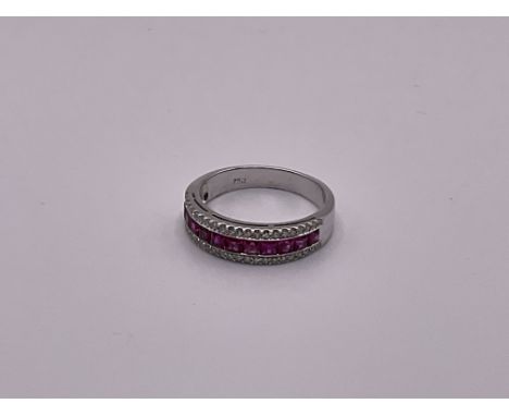 An 18ct white gold ruby and diamond ring.