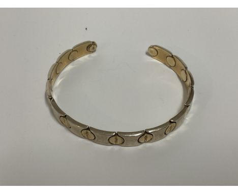 A 9ct gold Cartier style bangle, approx 13.6g.