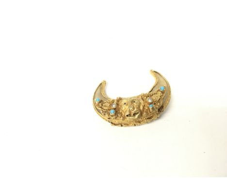 A high grade gold brooch with seed Pearl and turquoise and ruby eyes. 13.84g