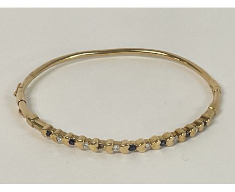 A Sapphire and Diamond set bangle in 9ct Gold