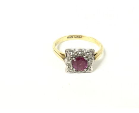 18ct gold ring with square face set with central ruby and surrounded by diamonds. Size M and 3.46g.