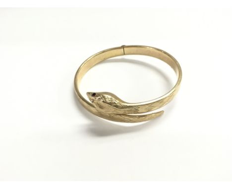 A 9ct gold bangle weighing 20.60g