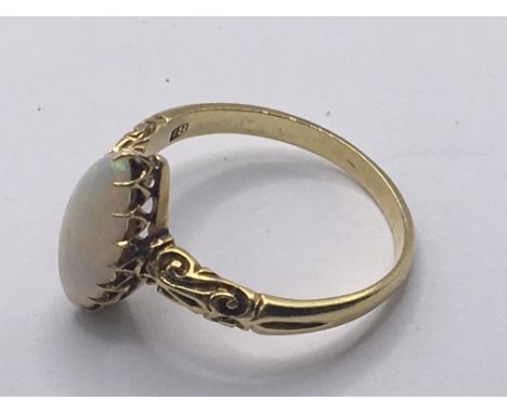 An 18carat gold ring set with an oval Opal. Weight 4g ring size R.