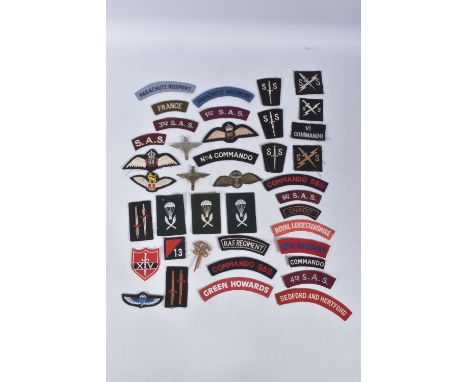 A BOX CONTAINING OVER FORTY UNIT AND FORMATION PATCHES, SAS, SBS, COMMANDO, AND OTHER ARMY UNITS AND THREE  METAL BADGES, all