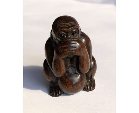 JAPANESE  CARVED HARDWOOD NETSUKE OF A CROUCHING MONKEY