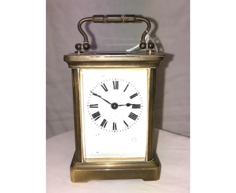 AN ACG BRASS CARRIGE CLOCK,WHITE ENAMEL DIAL WITH HAIRLINE 14CM HIGH 
