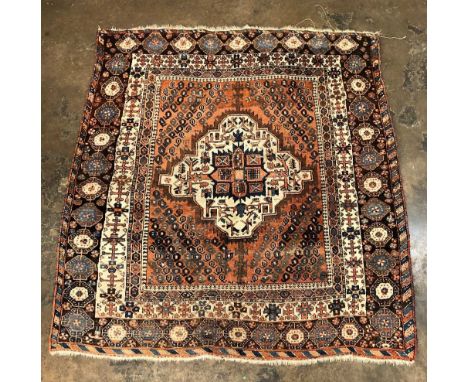 20TH CENTURY CAUCASIAN CARPET WITH A CENTRAL MEDALLION ON A CREAM GROUND WITHIN MAINLY RED AND ALTERNATING BORDERS.129CMX139C