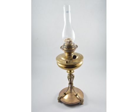 Brass oil lamp, Art Nouveau style with scrolled tripods, including funnel and globe, height 70cm.