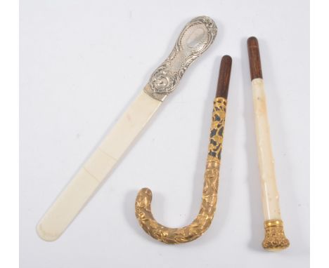 Silver handled ivory page turner, together with a yellow metal parasol handle with scrolling foliate design and a short secti