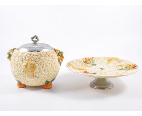 Two items of Clarice Cliff Celtic Harvest, including a biscuit barrel with chromed cover, and a sandwich plate raised on a ch