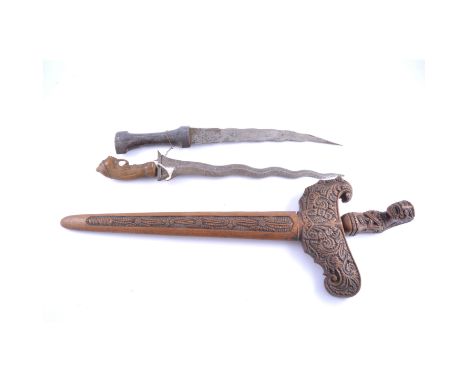 Malay Kris, 37cm watered blade, with separate extended guard, carved figural handle, in an elaborately carved hardwood scabba