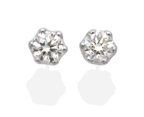 A Pair of 18 Carat White Gold Solitaire Diamond Earrings, a round brilliant cut diamond in a claw setting, total estimated di