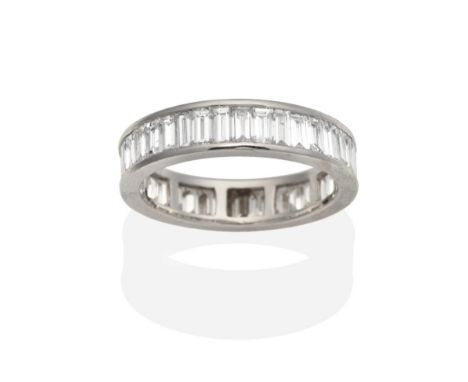 A Platinum Diamond Eternity Ring, of channel set baguette cut diamonds, total estimated diamond weight 5.20 carat approximate