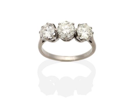 A Three Stone Diamond Ring, graduated round brilliant cut diamonds in claw settings, to knife edge shoulders, total estimated