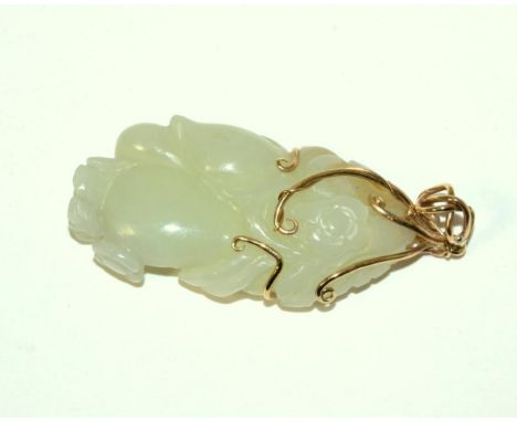 A Chinese Jade Carving, naturalistically modelled with fruit and flowers, 5.5cm high, mounted as a pendant