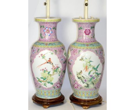 A Pair of Chinese Porcelain Vases, painted in famille rose enamels with birds and flowers in panels on a pink ground, 46cm hi