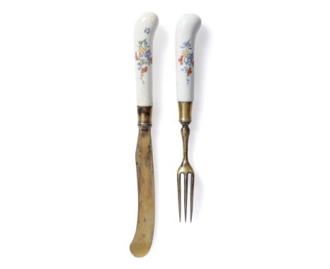 A French Porcelain-Handled Dessert Knife and Fork, probably Chantilly, circa 1740, the handles of pistol grip form, painted i