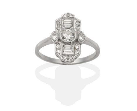 An Art Deco Style Diamond Ring, an old cut diamond spaced by channel set baguette cut diamonds and within a frame of milgrain